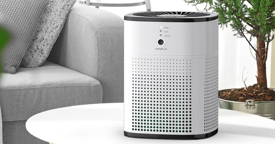 white air purifier on white table in living room