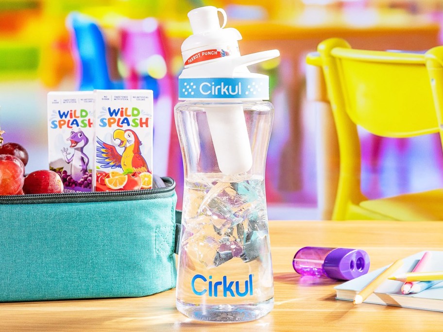 water bottle on school desk with flavor cartridges in background
