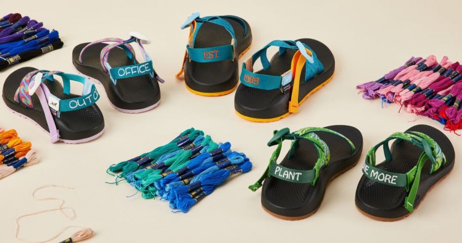 3 pairs of custom Chacos sandals next to bundles of embroidery floss
