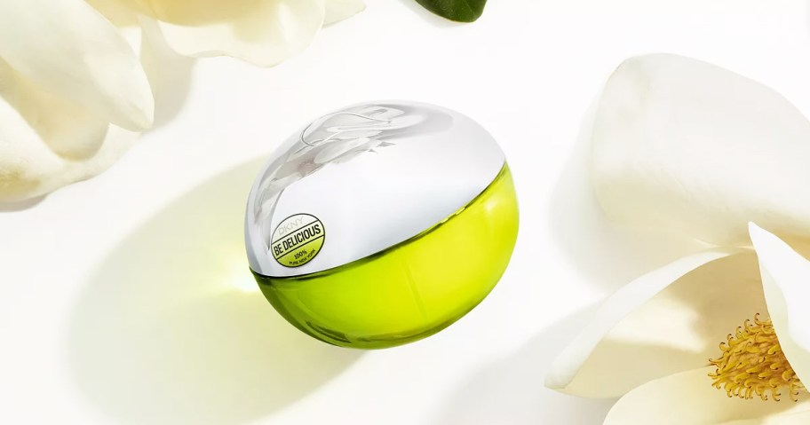 green and silver DKNY Be Delicious Fragrance bottle near white flowers