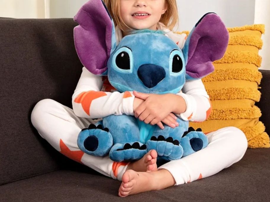 kid holding Disney Lilo & Stitch Plush Pillow Buddy on couch