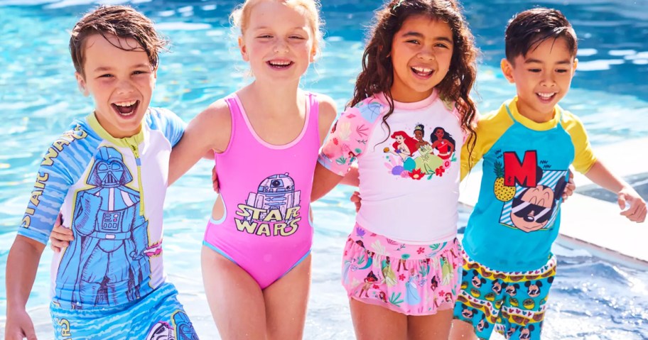 four kids wearing disney swimwear at pool