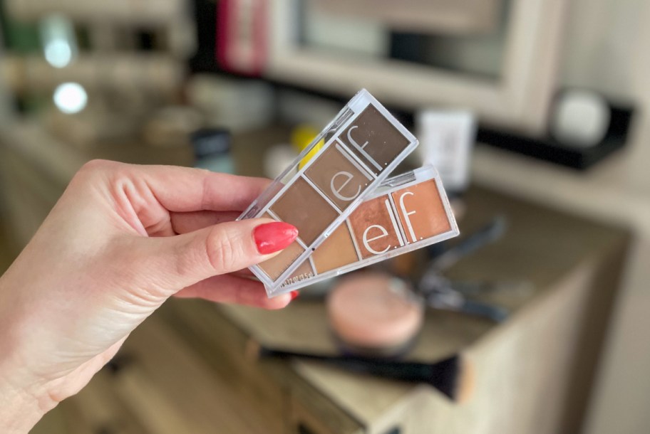 hand holding e.l.f. Cosmetics bite-sized eyeshadow palettes available from Walmart