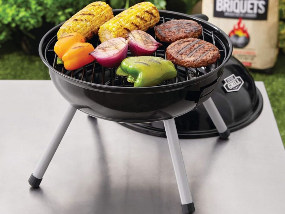 A small, portable grill with food on it 