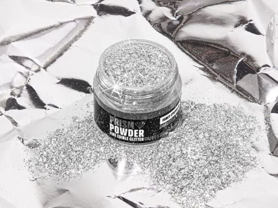 A Fancy Sprinkles Premium Edible Glitter Prism Powder Silver on a silver background 