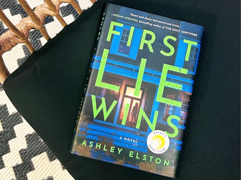 Harcover edition of First Lie Wins book set on a chair