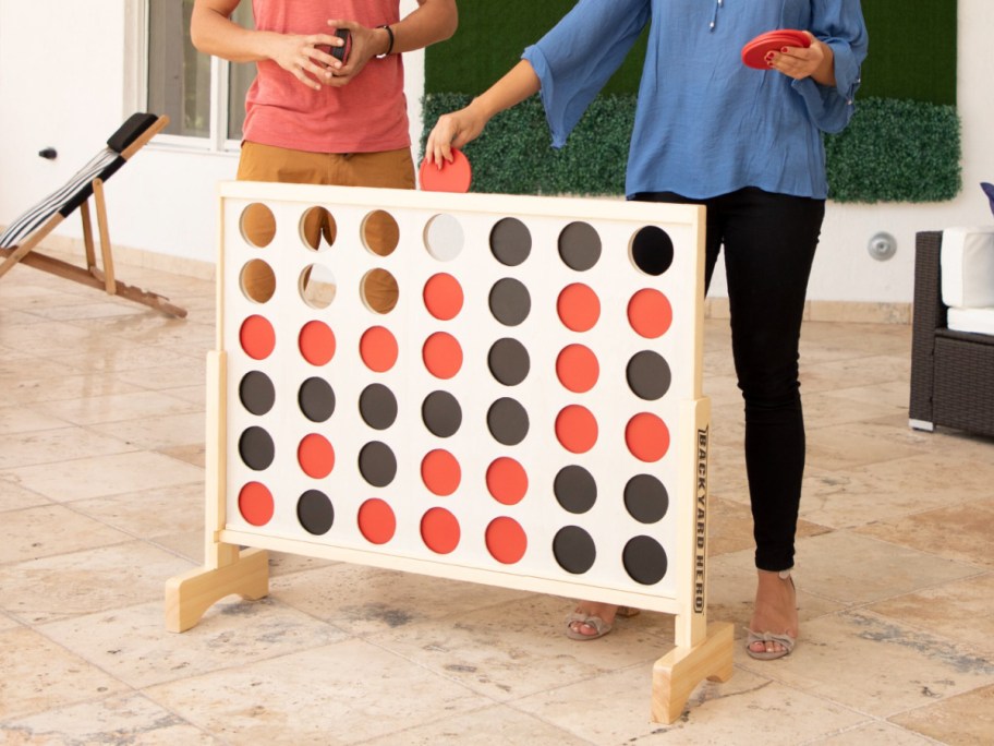 Two people playing Giant Connect 4 game 