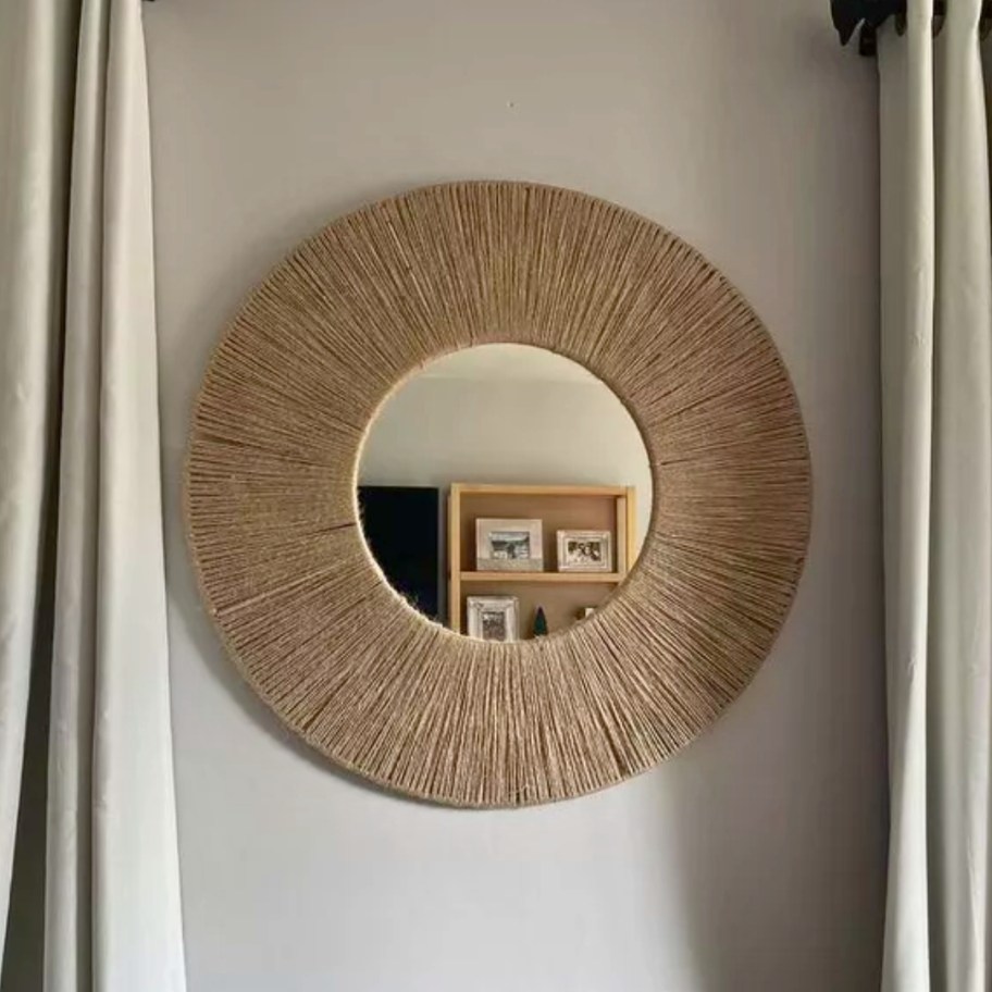 round wall mirror with wrapped jute on a wall