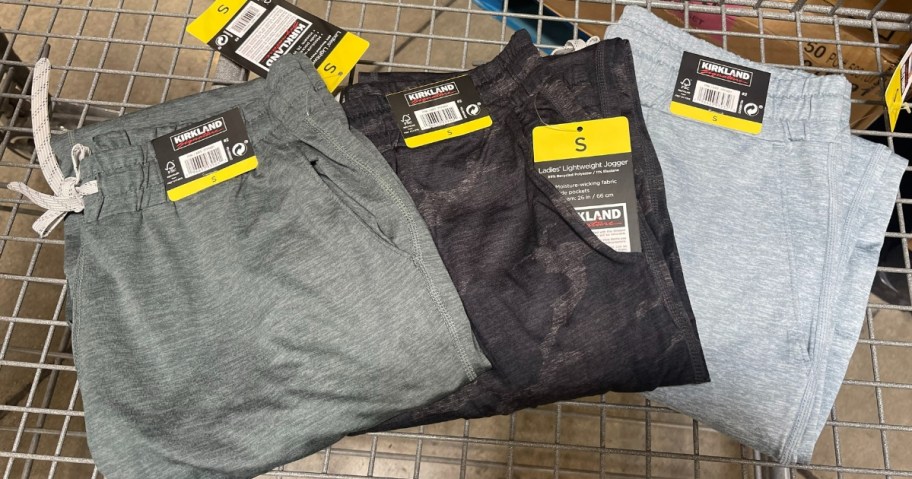 3 pairs of women's joggers with tags on them in a shopping cart
