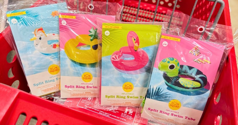 various kid's animal and pineapple shaped ring floats in packaging in a Target cart