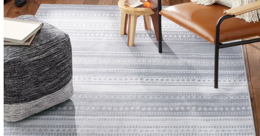light grey stripe and geometric design rug on a living room floor