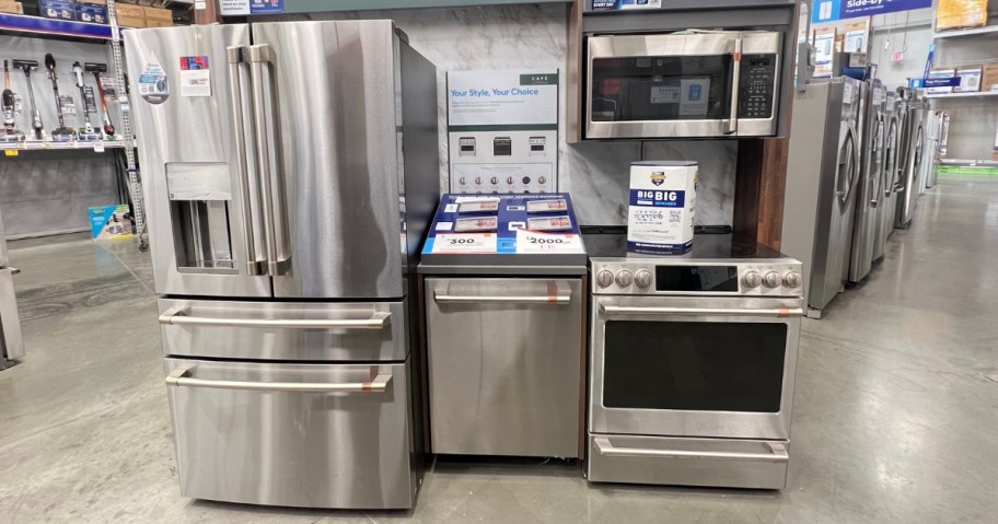 stainless steel fridge, dishwasher, oven and microwave on floor display at Lowe's
