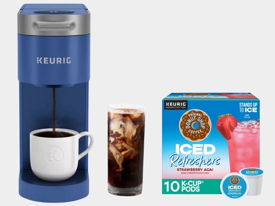 blue Keurig single cup coffee maker next to a box of Strawberry Acai iced k-cup pods