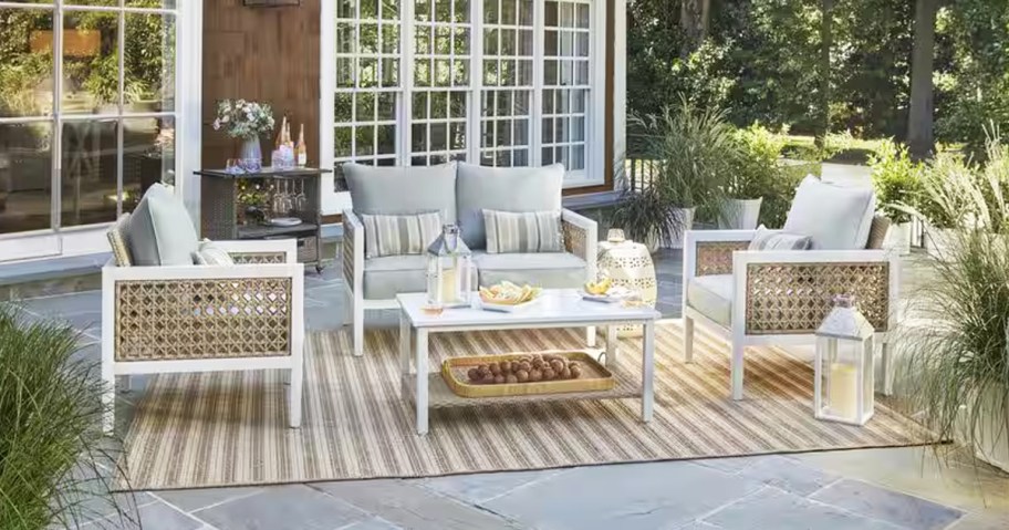 white patio conversation set with rattan sides and grey cushions