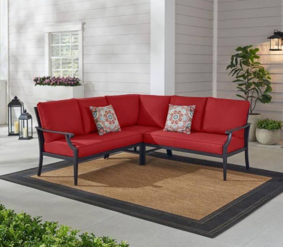 an outdoor sectional with red cushions