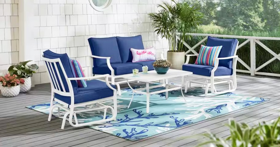 white metal conversation set with blue cushions