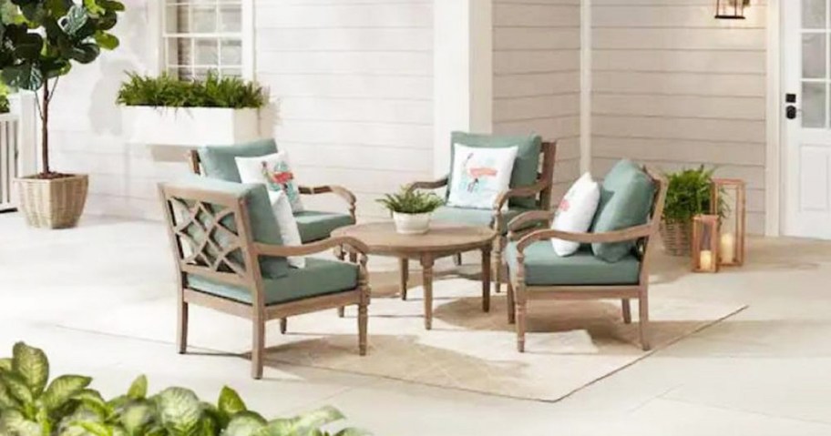 five piece patio set displayed over a rug