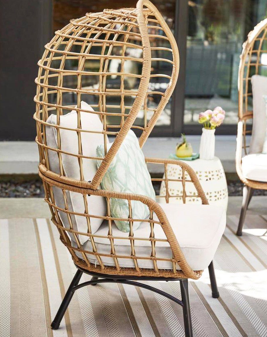 wicker patio chair with white cushions