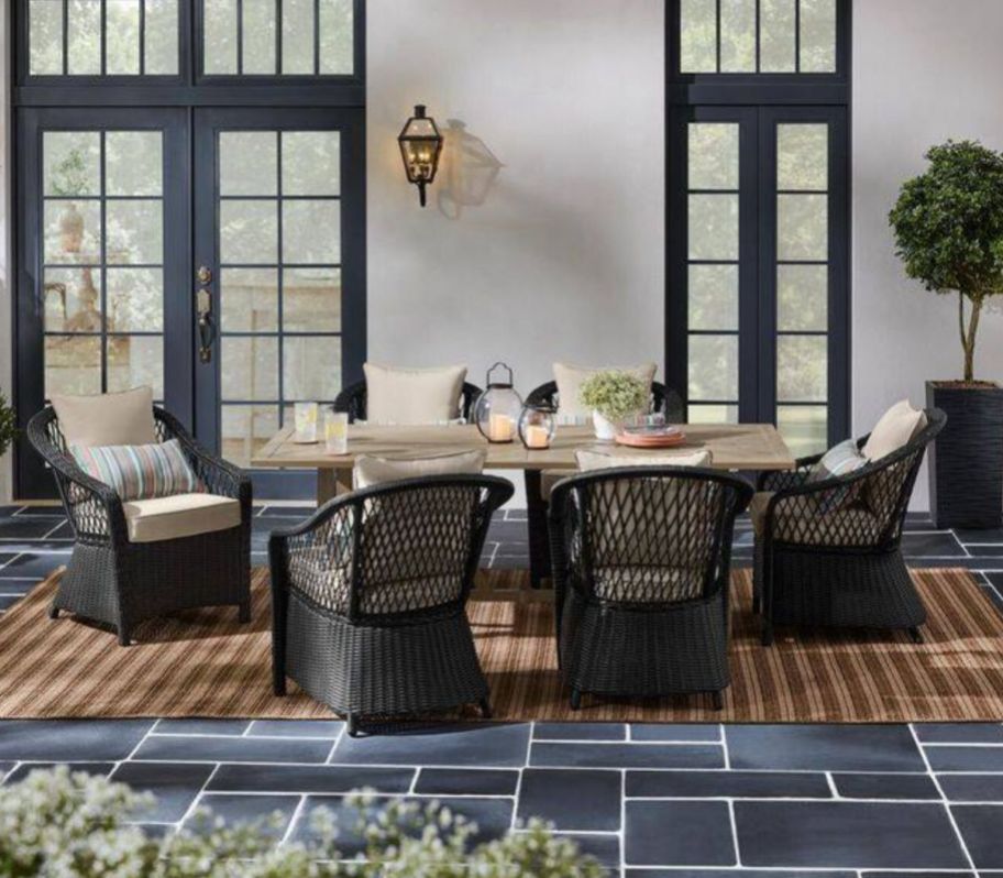 7 piece wicker outdoor dining set with a table and six chairs