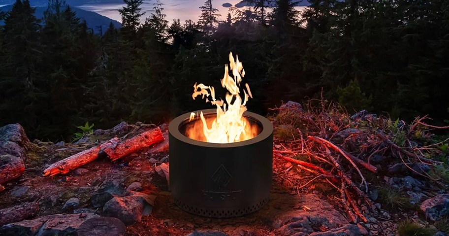fire burning in a round black fire pit