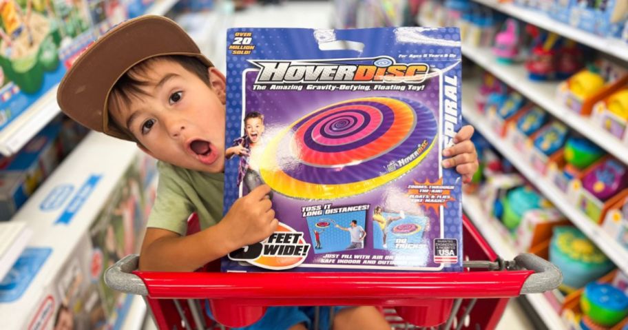 Little boy in a Target shopping cart with a HoverDisc Toy