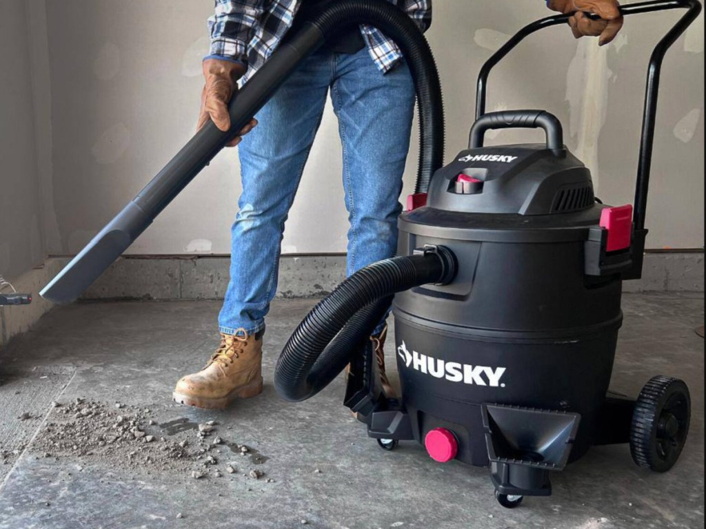 black husky shop vacuum being used in garage
