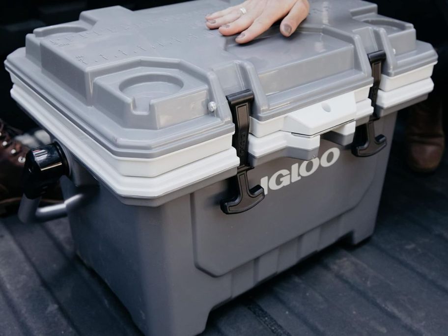 A person closing an Igloo Cooler in Grey