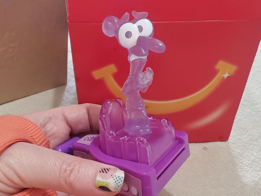 A hand holding an Inside Out 2 Happy Meal Character Fear