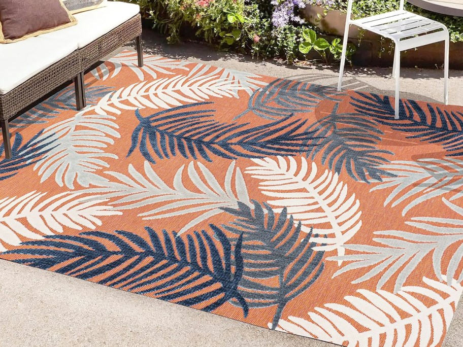 pink, blue, and white palm leaf print area rug