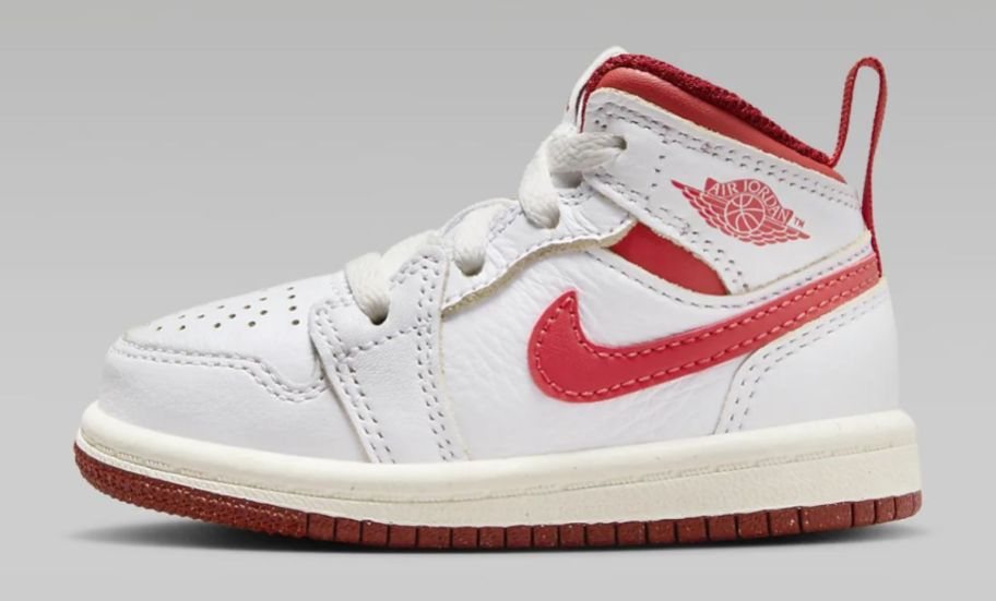 a white and red baby's hightop sneaker
