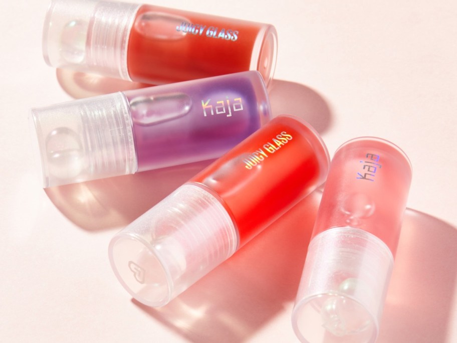 multiple tubes of Kaja Juicy Glass Lip Oils in various shades