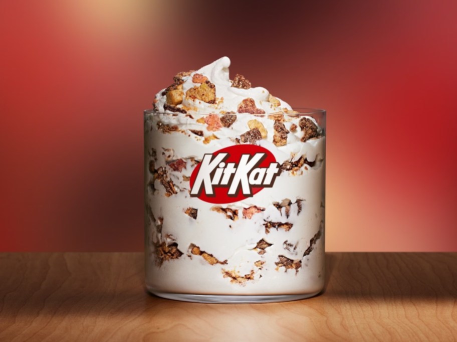 Kit Kat banana split McFlurry in a glass in front of a red background