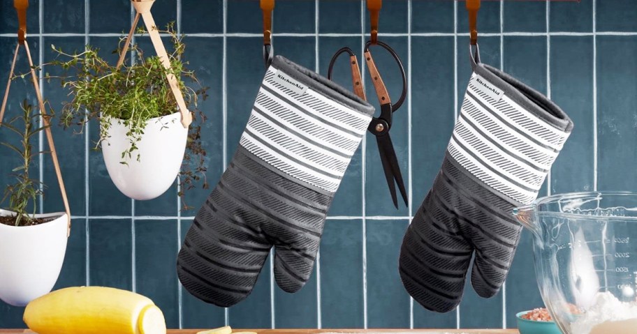 grey and white oven mitts hanging in kitchen