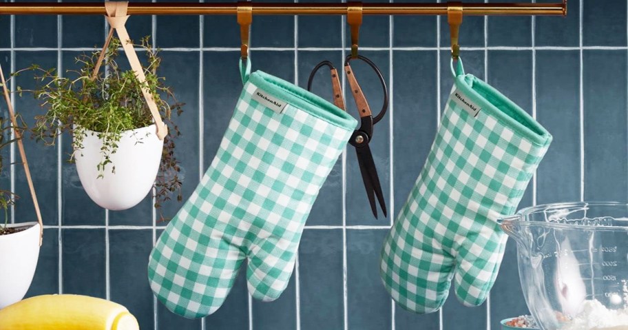 green and white gingham print pot holders hanging in kitchen