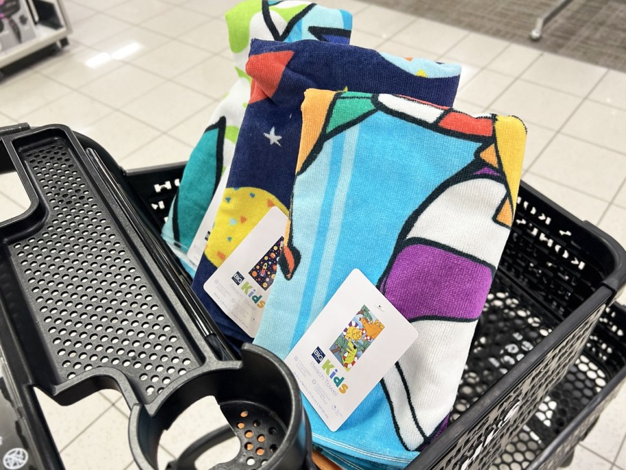 three kids beach towels in black shopping cart