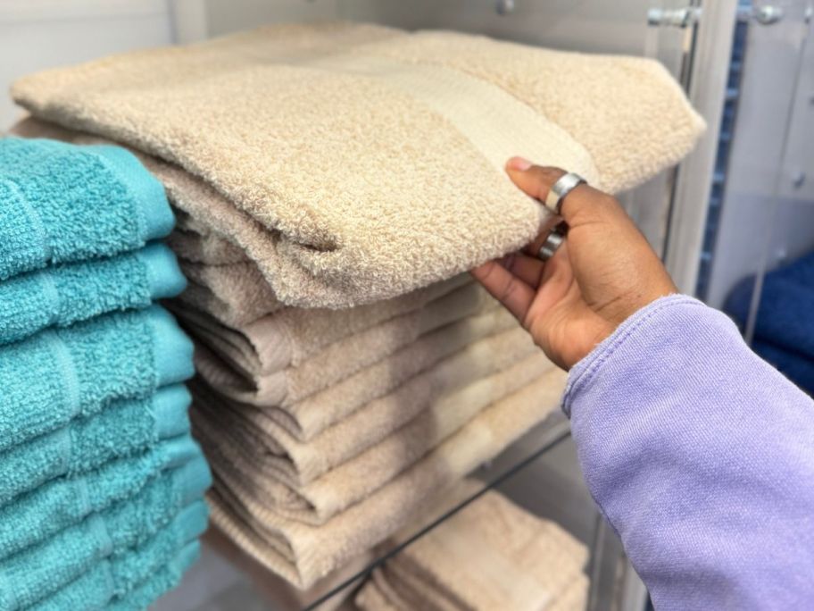 Hand touching The big one bath towels at Kohls