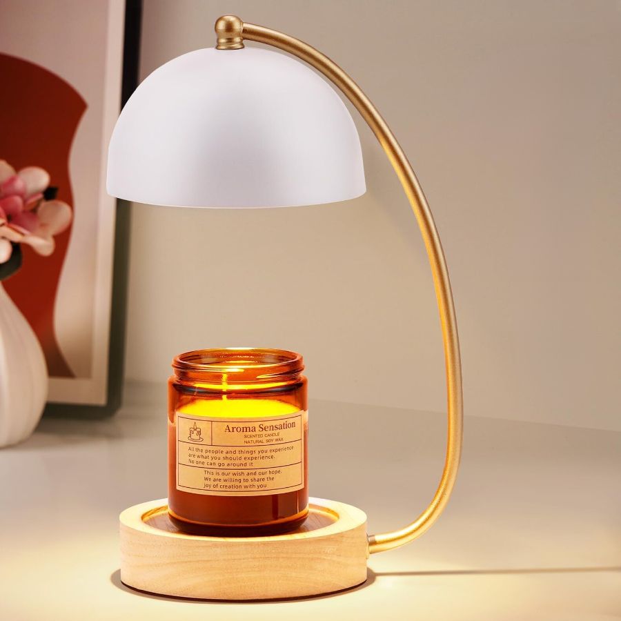 A gold candle warmer with white globe