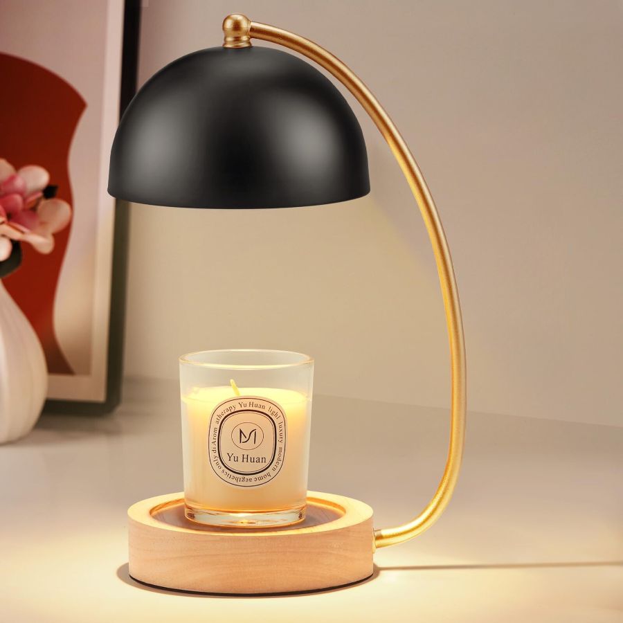 A gold candle warmer with black globe