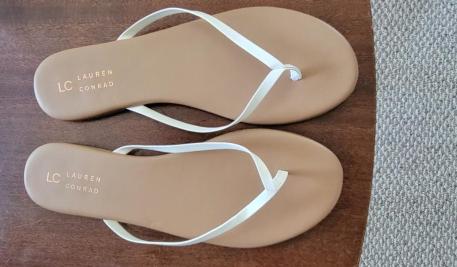 pair of tan and white flip flops