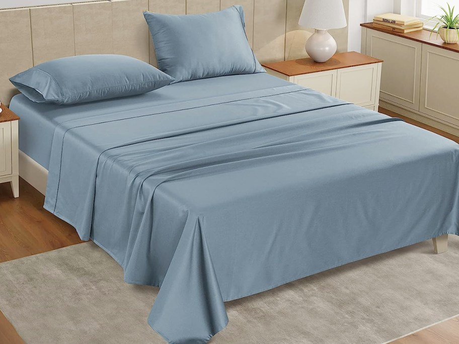 blue sheet set on a bed