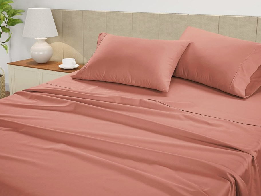 coral colored sheets on bed