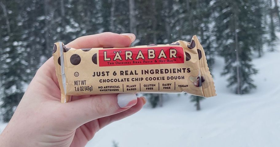 Woman's hand holding up a Chocolate Chip Cookie Dough Larabar