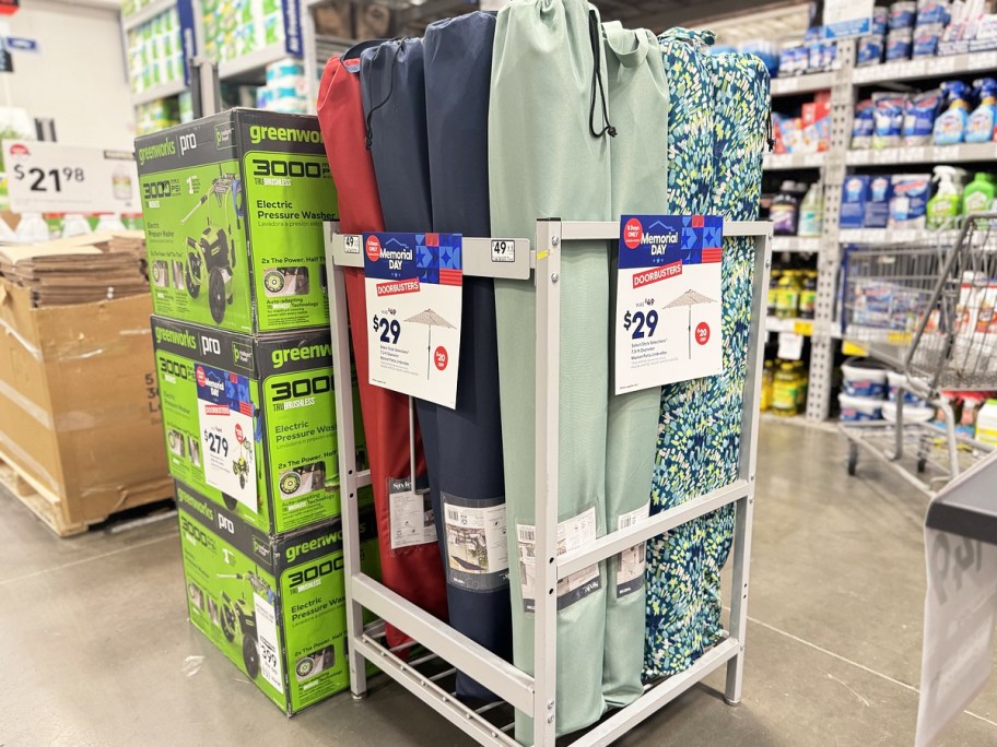 display of patio umbrellas in lowe's store with $29 sale sign
