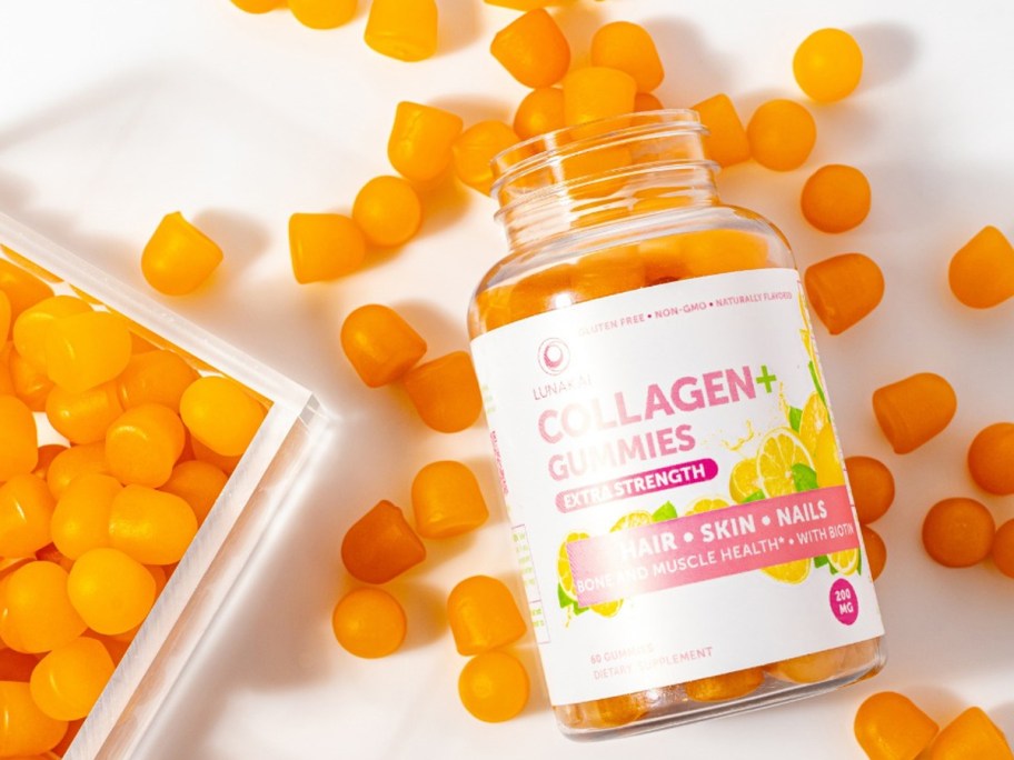opened bottle of Lunakai Collagen Gummies surrounded by orange gummies