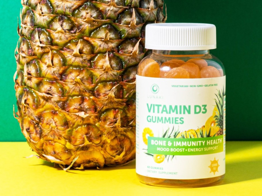 bottle of Lunakai Vitamin D3 Gummies next to a pineapple