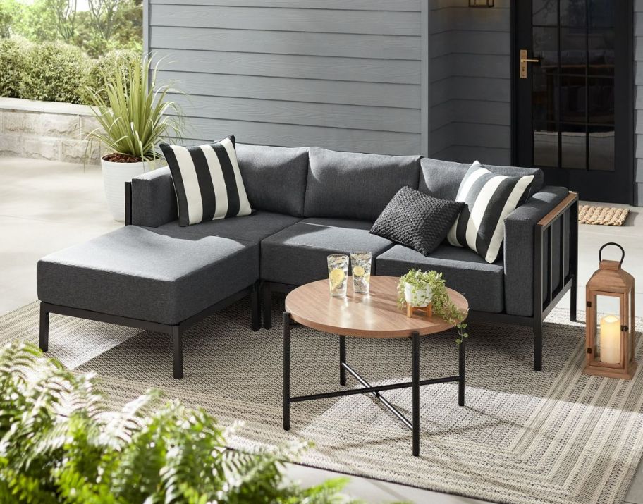 a gray 4 piece sectional with table on a patio