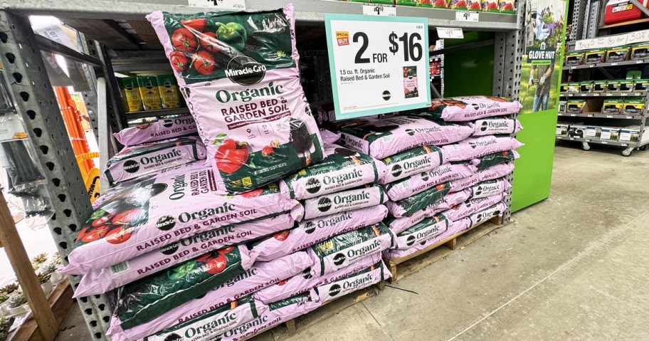 pink bags of Miracle-Gro Organic Raised Bed & Garden Soil on sale at Home Depot