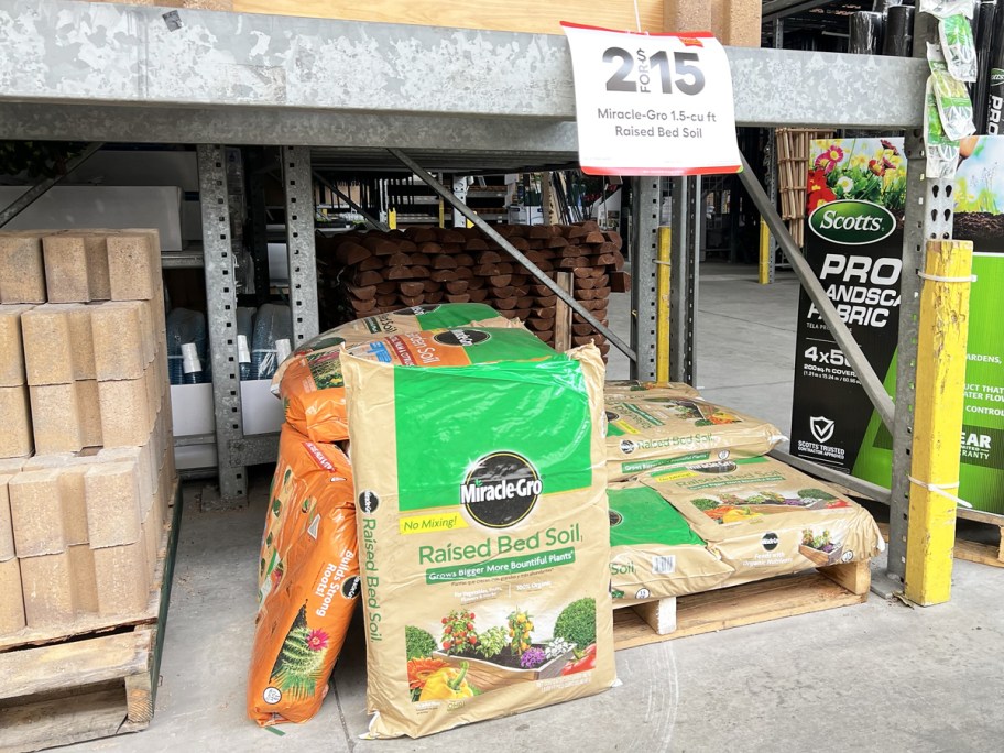 bags of Miracle-Gro Raised Bed Soil at Lowe's with 2/$15 sale sign