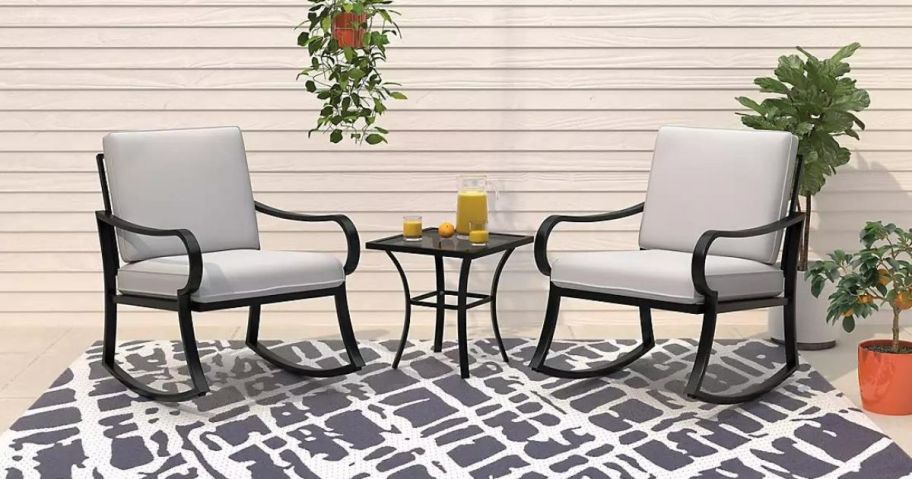 A Mosaic 3-piece Patio Set with 2 chairs and a table on an outdoor rug