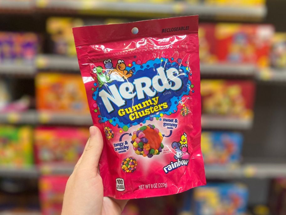 Hand holding a bag of Nerds Rainbow Gummy Clusters